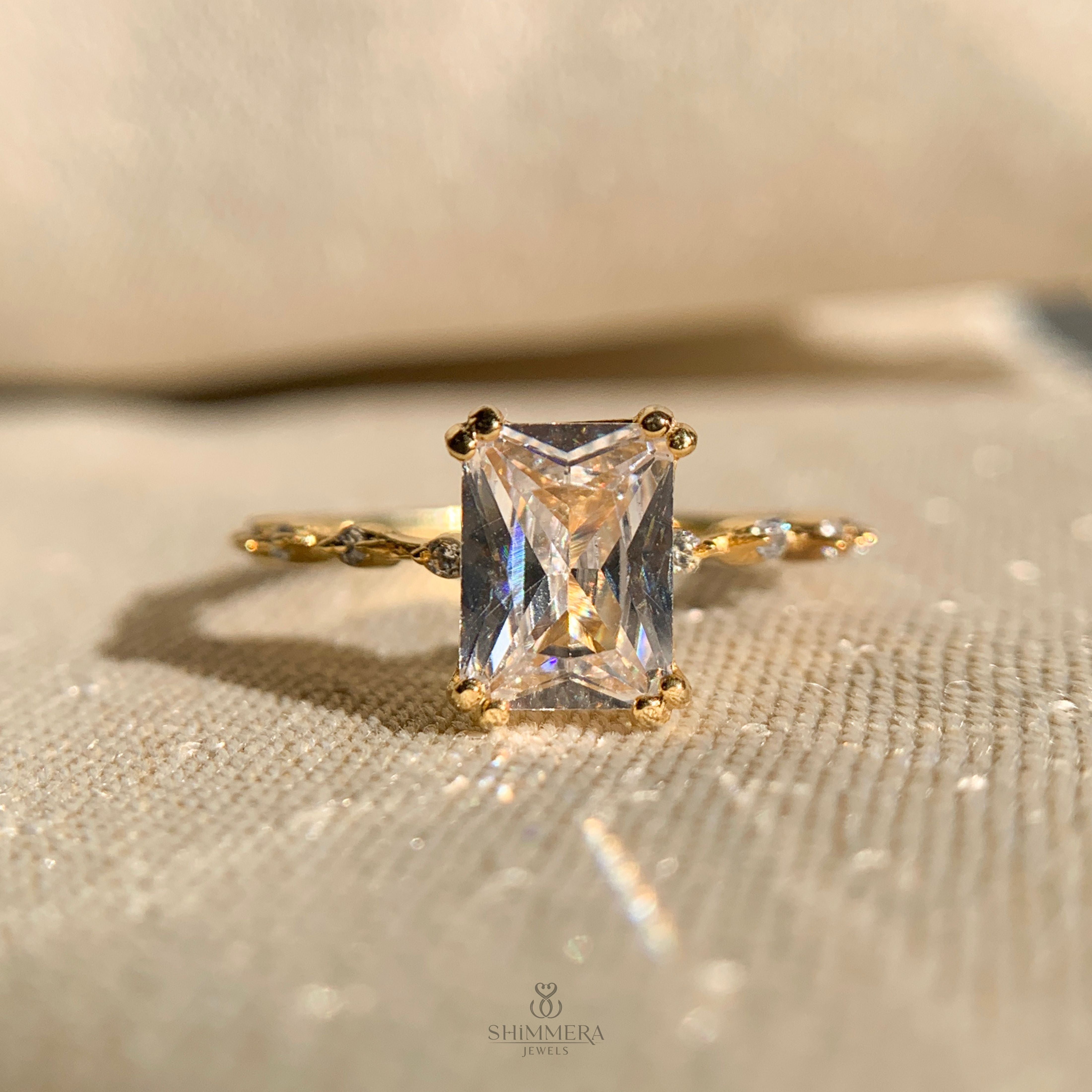 Radiant cut engagement ring with sparkling side stones in white gold